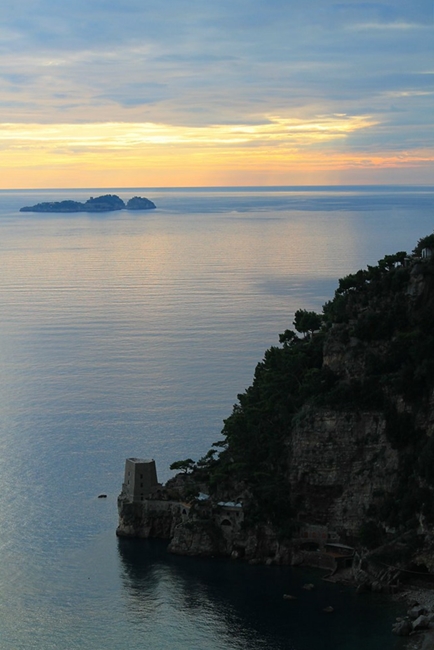 Gli isolotti Li Galli nell'ora del crepuscolo. In primo piano la Torre di Clavel, Positano - Ph. Michael Costa | ccby2.0